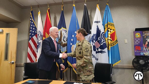 Dr. Michael Jordan, Vice President of Service to the Armed Forces and International Services at the American Red Cross, shakes hands with Colonel Megan B. Stallings, Commander, U.S. Military Entrance Processing Command, after signing the historic MOU that aims to give the Red Cross Emergency Communications brief to 100% of military recruits.